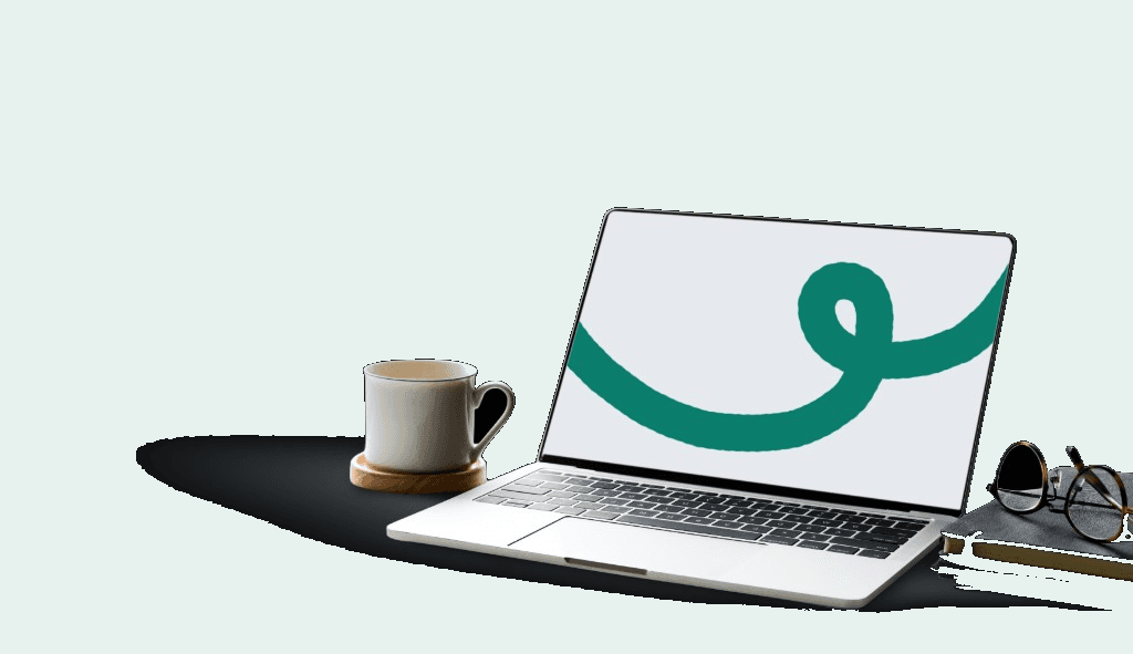 Laptop, mug and glasses on a desk